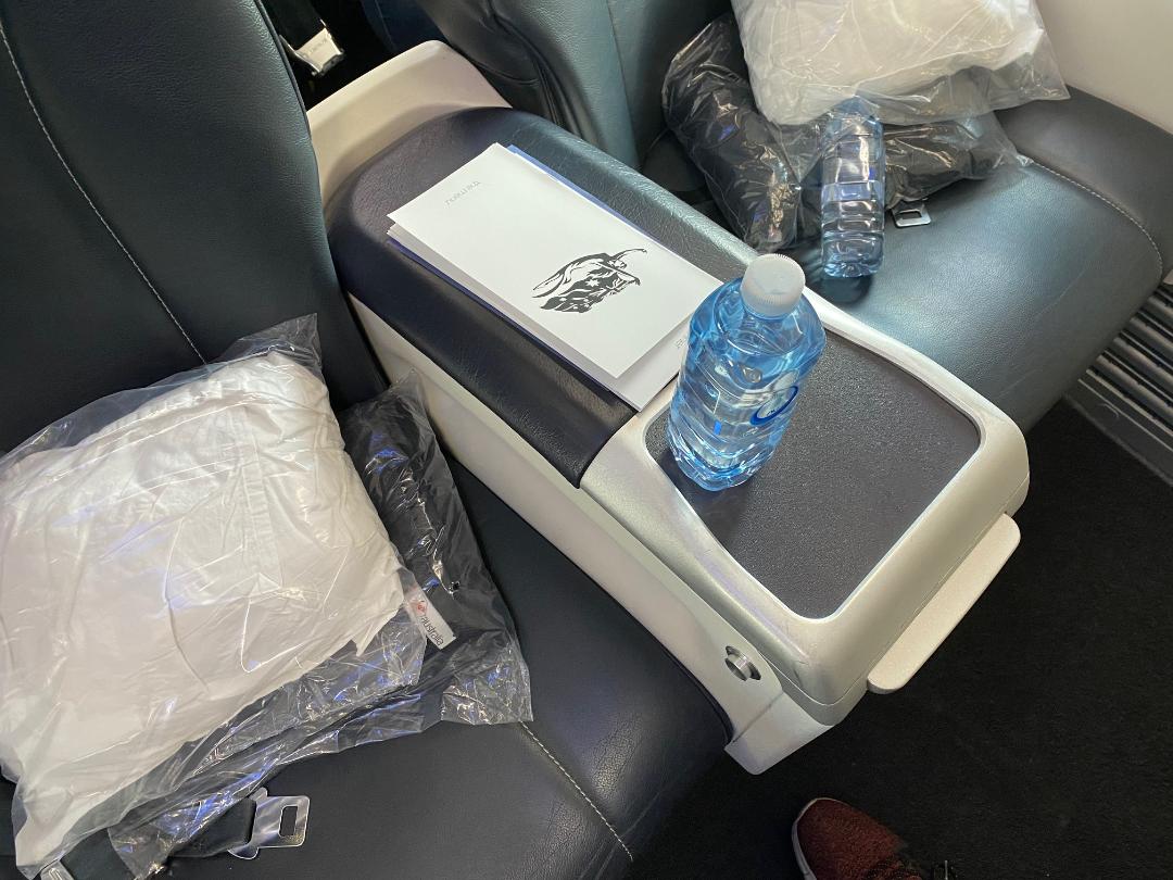 Blankets, pillows and water bottle on Virgin Australia Business Class, B-737